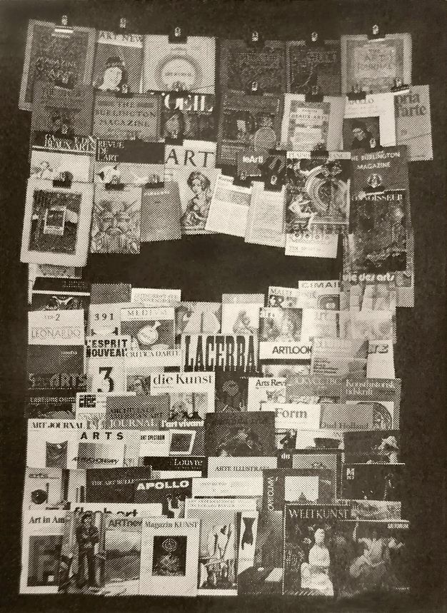Illustration. Black and white photograph of about seventy journal covers, some clipped to wires across the top and others stacked below. Titles are in English, German, and French, among others.
